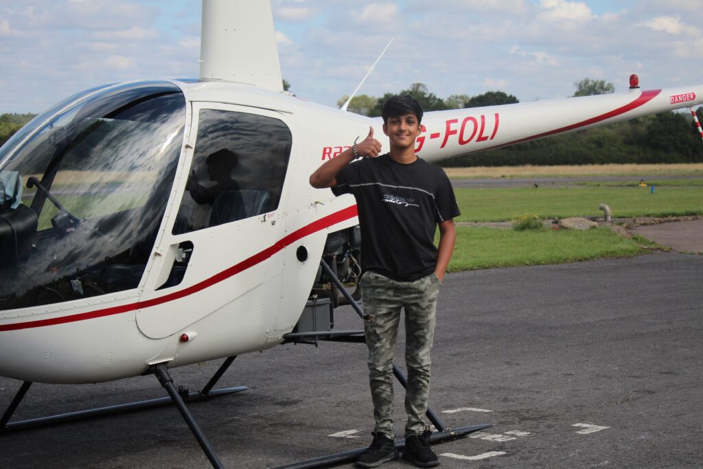 Person standing in front of helicopter