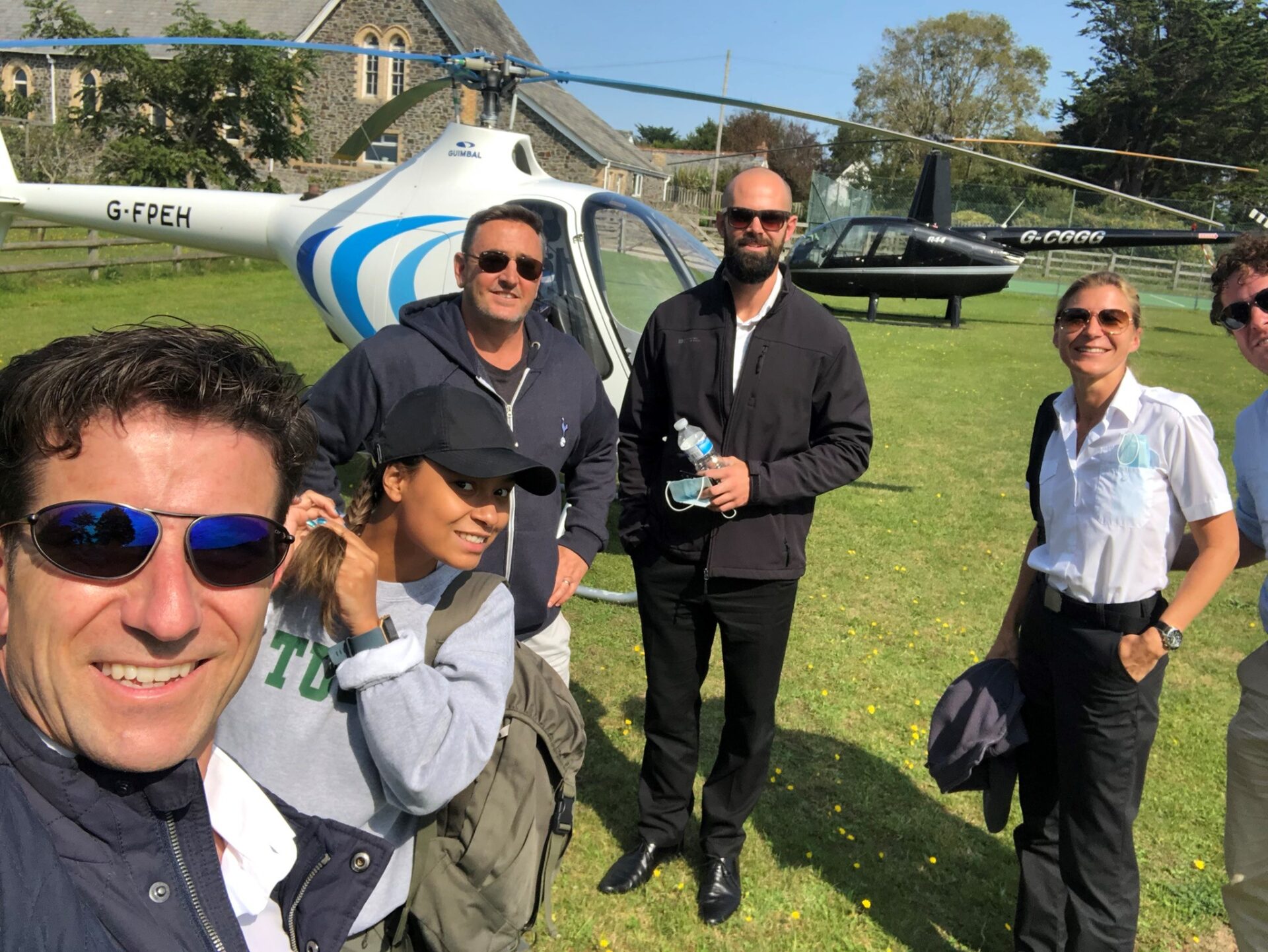 People standing in front of helicopter